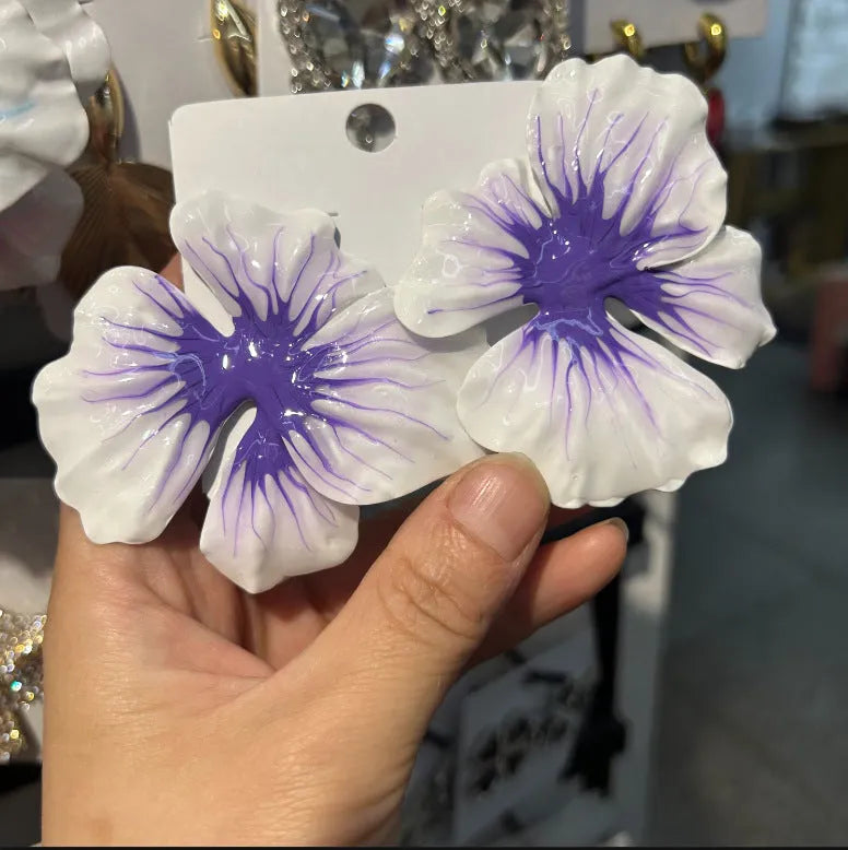 Close-up of women's alloy flower stud earrings with a blue oil-spot glaze and electroplated finish.