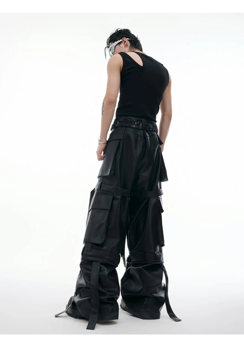 Black loose-fit retro leather-look pants with quilted texture and multi-pocket stitching detail.
