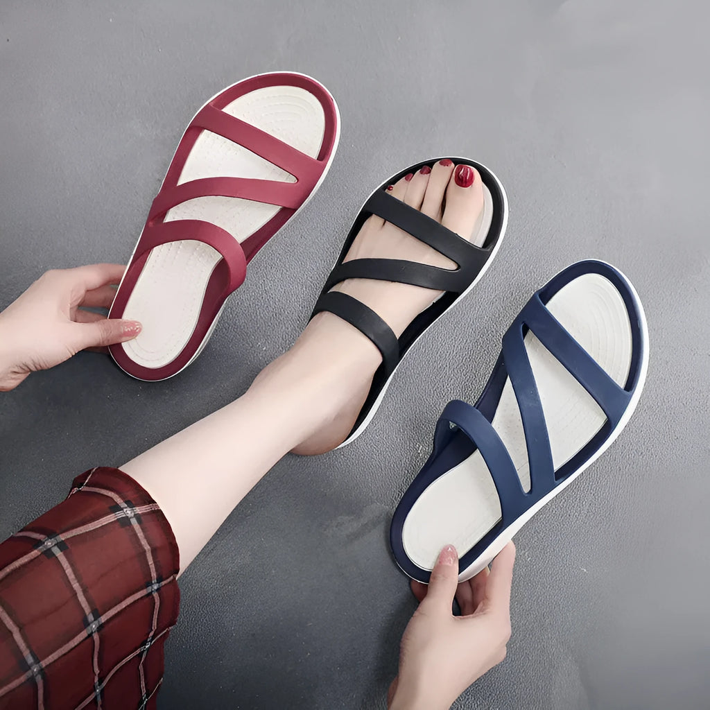 Women's solid colour breathable summer sandals in red, shown from the side.