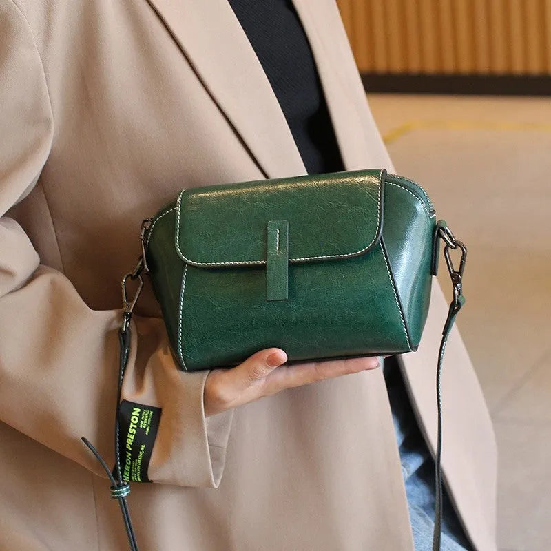 Women's brown oil wax leather messenger bag with crossbody strap and multiple internal pockets