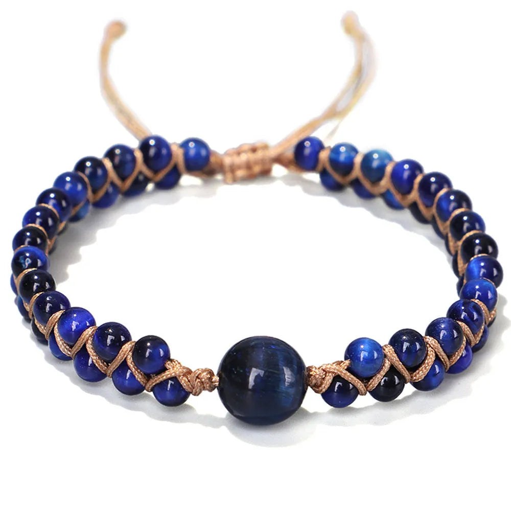 Handwoven geometric pull bracelet made from blue Tigereye stone on a wrist.