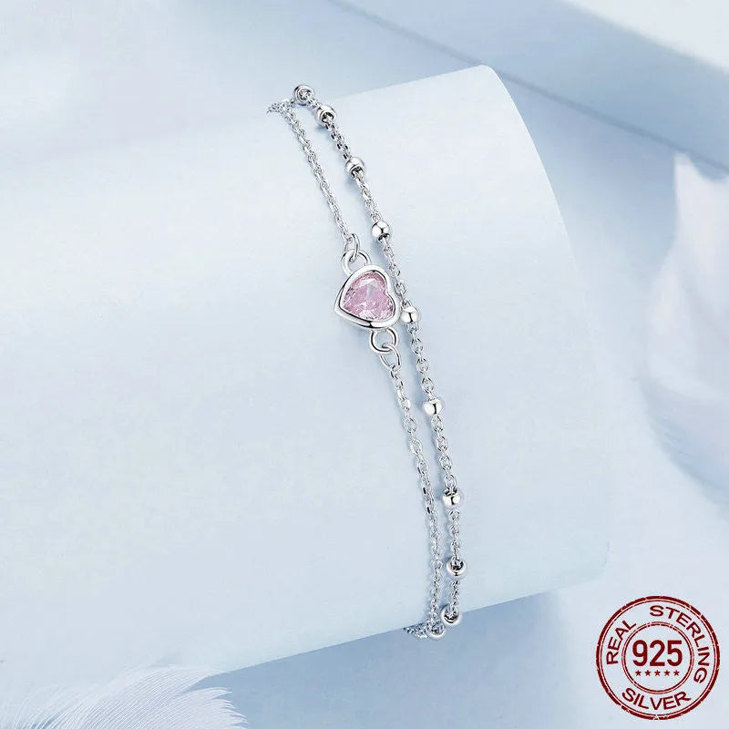 Women's 925 sterling silver bracelet with a small heart charm on an adjustable chain.