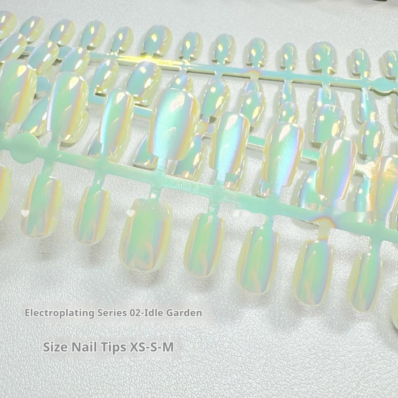 Electroplated Cat's Eye false nail set showing aurora armour and solid colour styles in short ladder sizes.