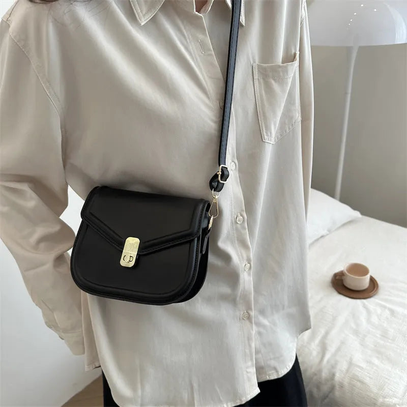 Soft textured PU shoulder messenger bag in horizontal square clamshell design.
