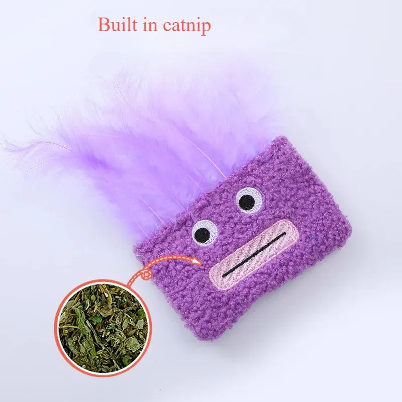 Colourful cat plush toy with a big mouth explosion head shape on a plain background.