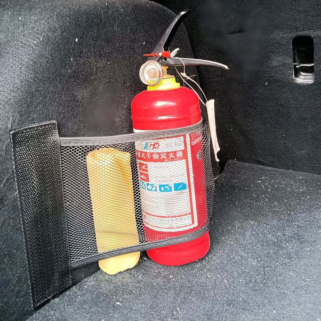 Elastic car boot storage net organiser holding various loose items securely in place