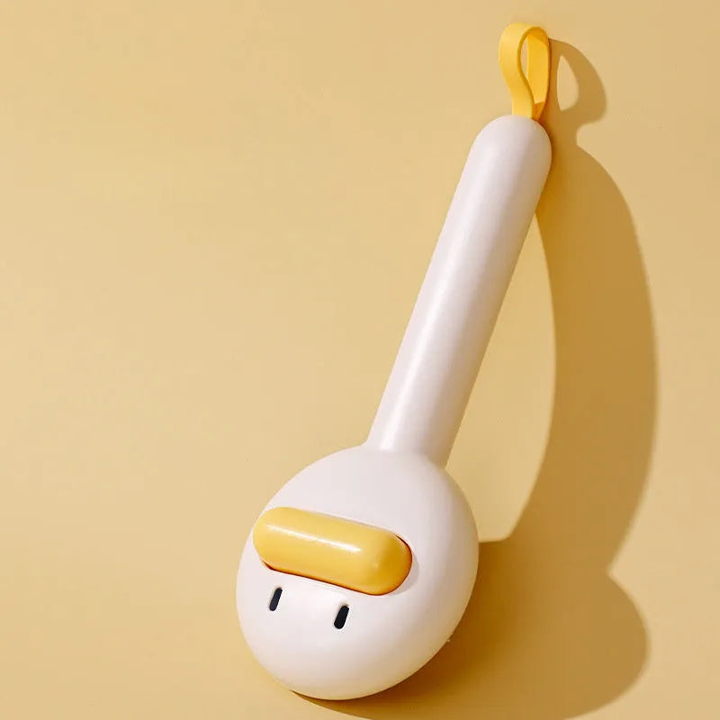 Small yellow duck-shaped pet grooming comb with open section and needle teeth