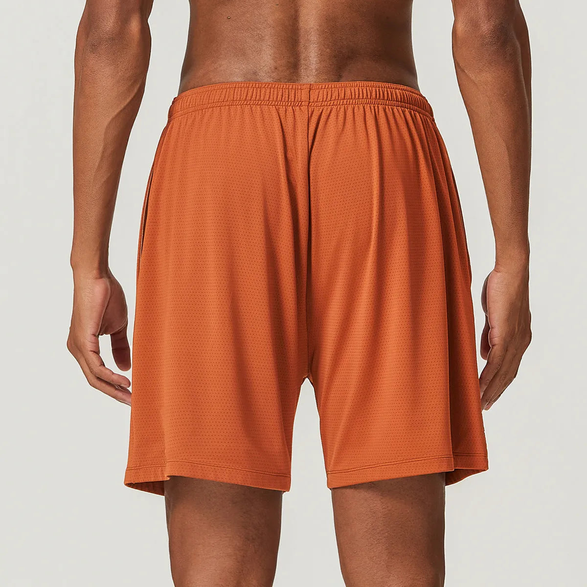 Man's quick-drying athletic shorts in khaki colour, showing double-layer construction and mid-waist fit.