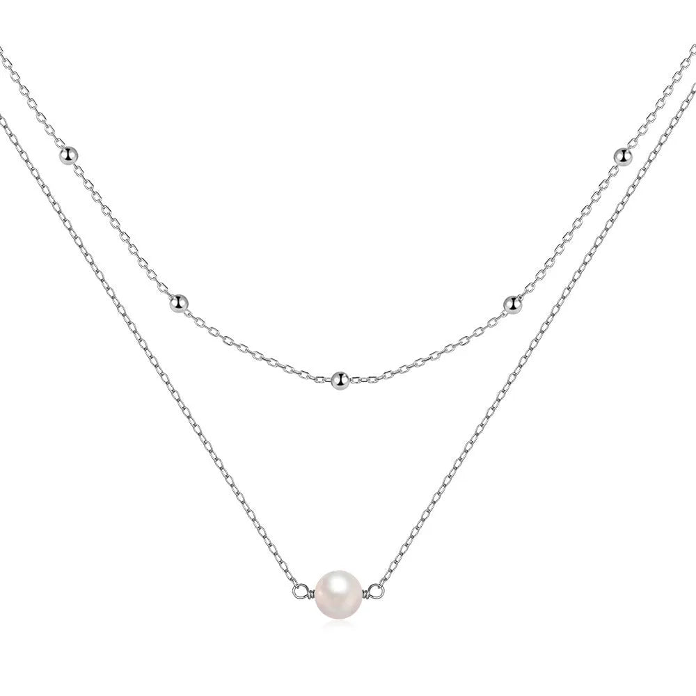 S925 sterling silver double layer necklace with twin pearls on a geometric pendant, shown in gold and white gold finishes.
