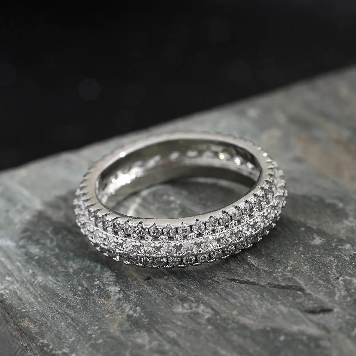 Geometric triangle zircon ring in three colour options showing detailed inlay work