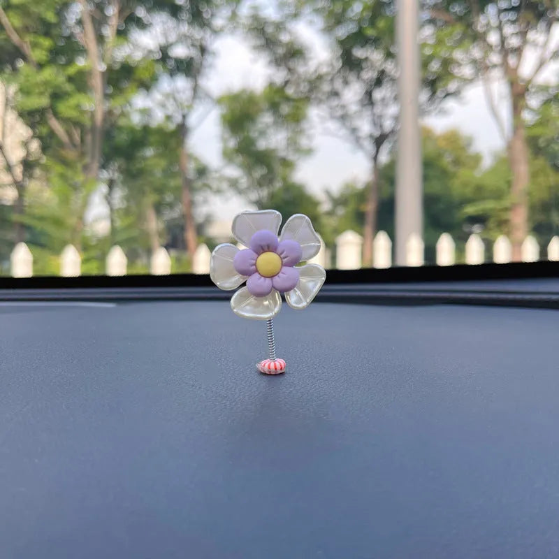 Small plastic swing decoration for car dashboard measuring 50mm by 35mm in multiple colours