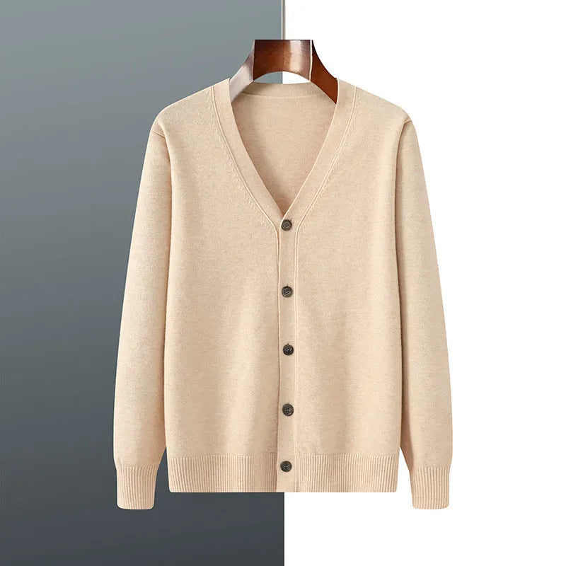 Man wearing a beige V-neck Andy velvet cardigan coat with a loose fit and long sleeves.