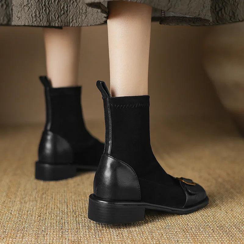 Women's black low-heel Martin ankle boots with front lace-up and belt buckle detail stitching.