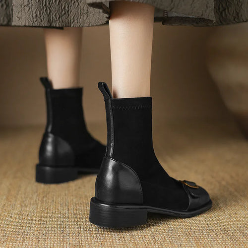 Women's black low-heel Martin ankle boots with front lace-up and belt buckle detail stitching.