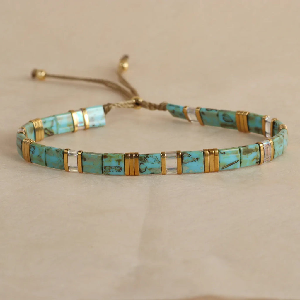 Geometric pull bead bracelet with round glass beads in multiple colour options.