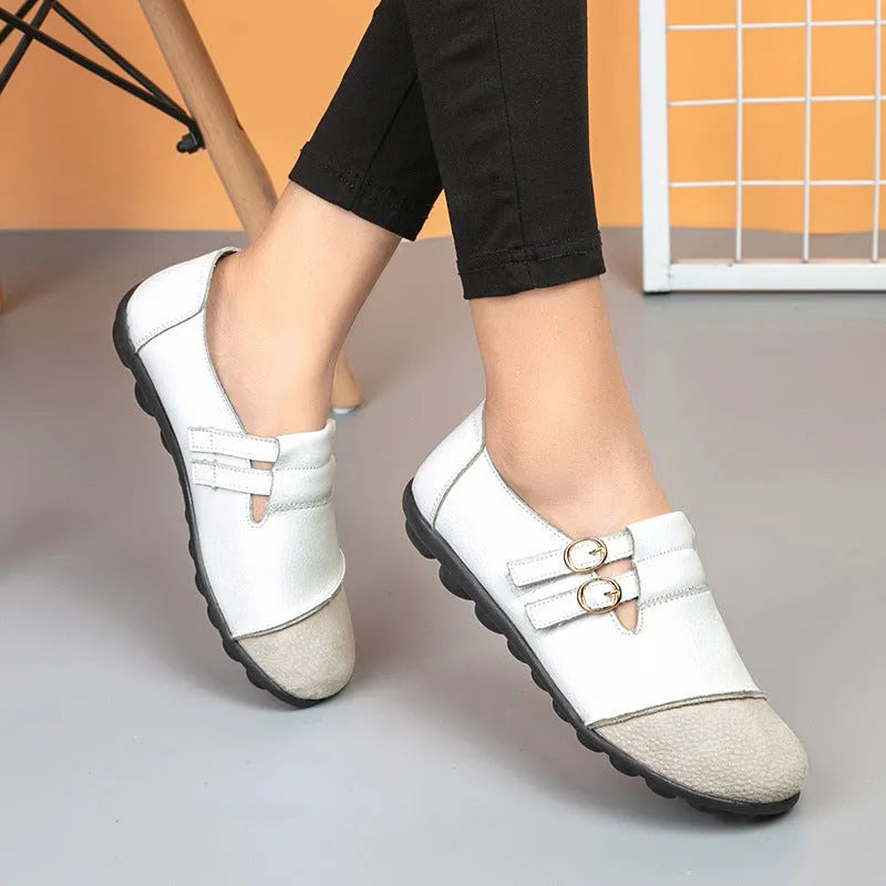 Women's casual round-toe flat shoes with a black Velcro strap on a cow leather upper.