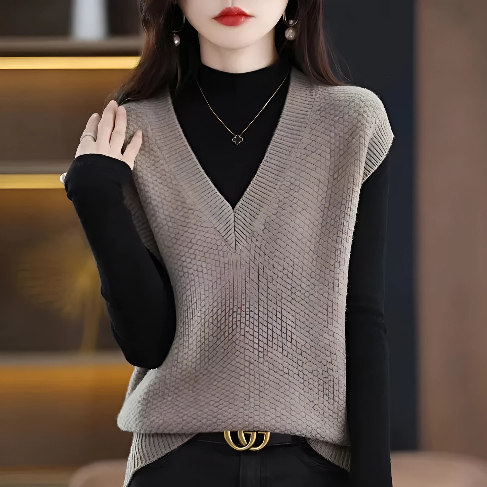 Sleeveless pullover vest with 3D knit pattern in creamy-white colour, shown on hanger