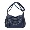 Large black PU shoulder bag with multiple internal compartments showing phone and document sections