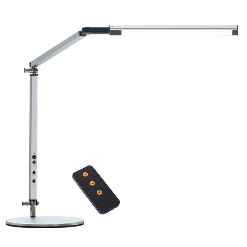 Folding aluminium desk lamp with a metal clip, shown in dazzling black, attached to a desk edge.