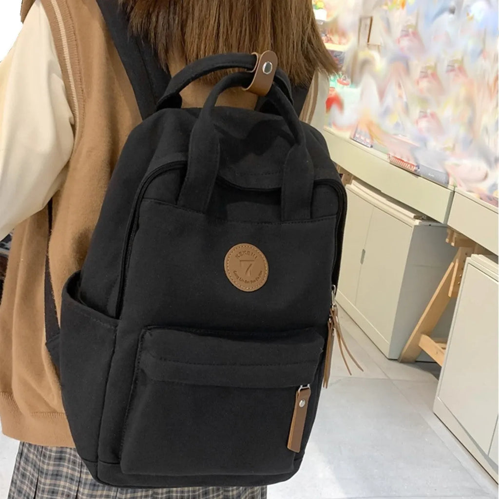 Black Oxford cloth backpack with curved shoulder straps for school and travel use