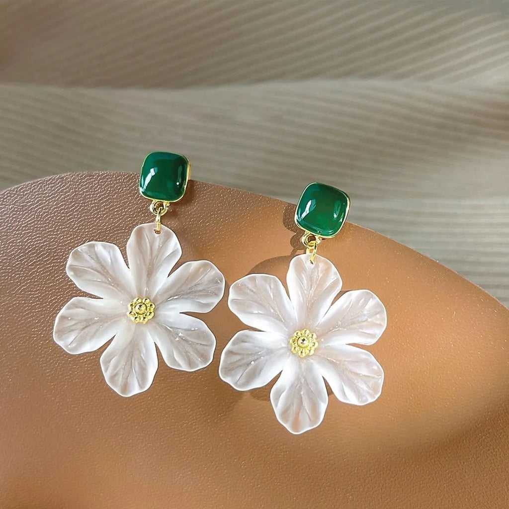 A pair of dark green alloy earrings with a detailed needle flowers sweet floral design.