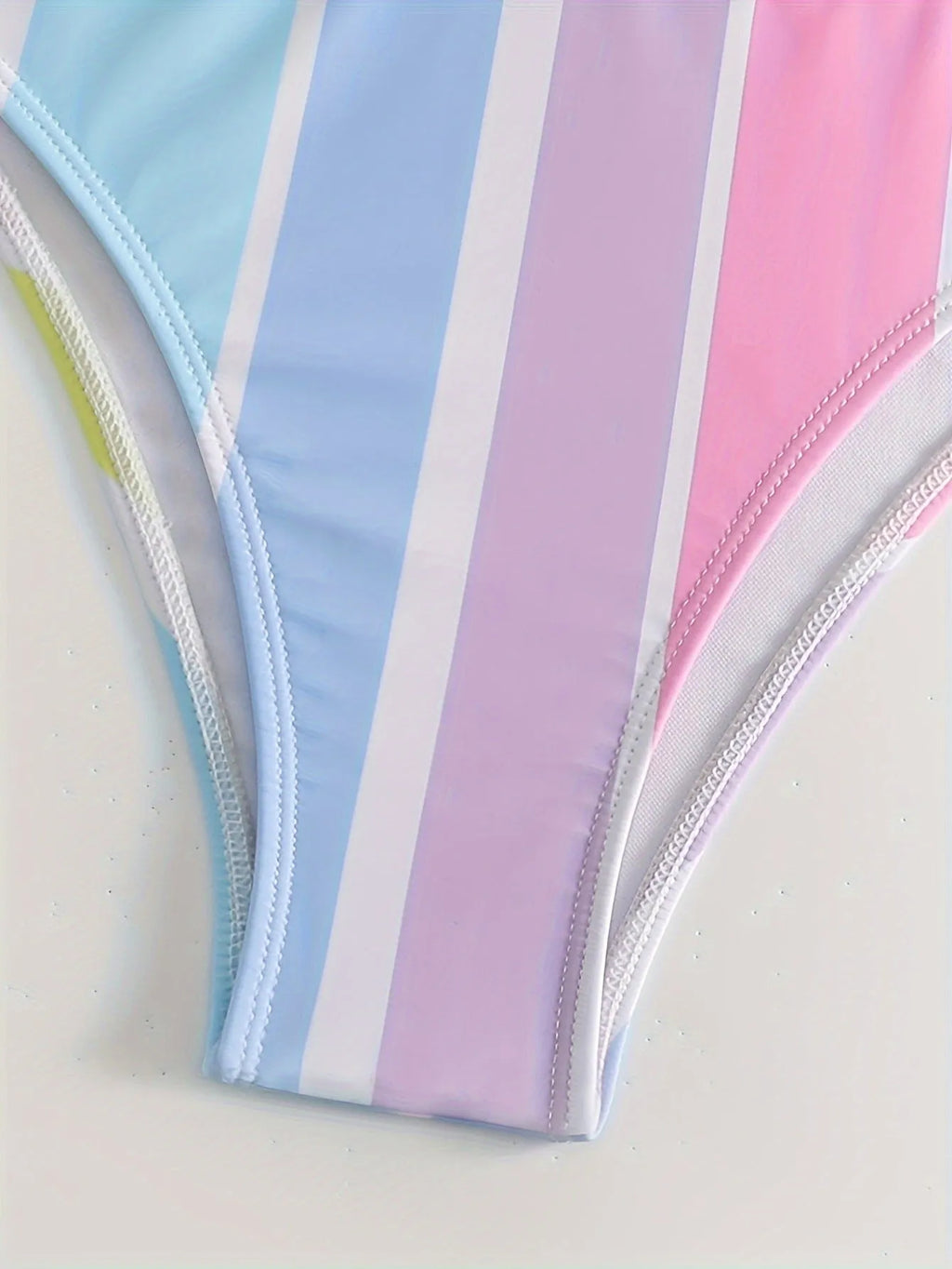 Women's striped two-piece sports bikini swimwear set on a mannequin.