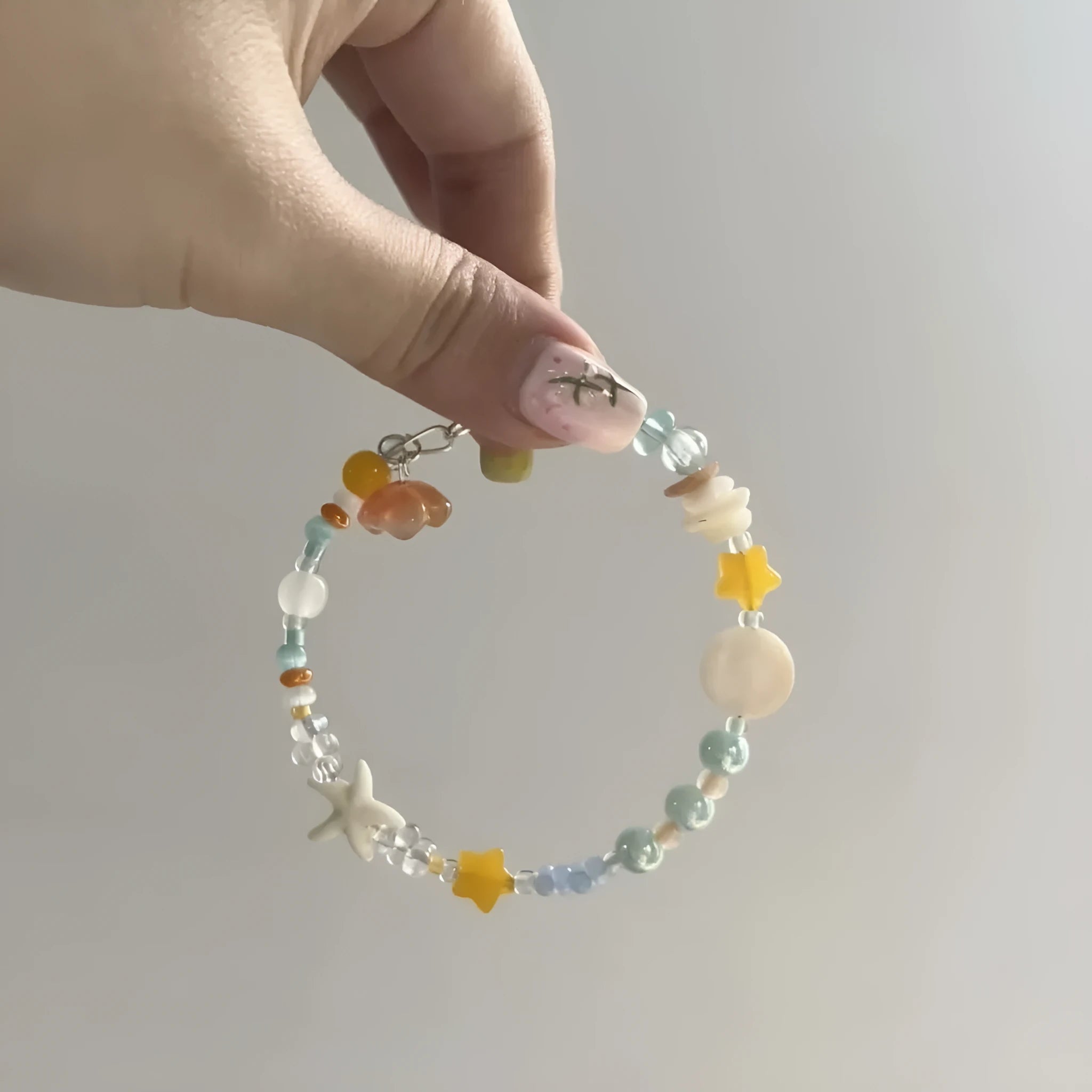 Orange alloy charm bracelet with mixed materials, diamond and round elements, adjustable seaside summer design