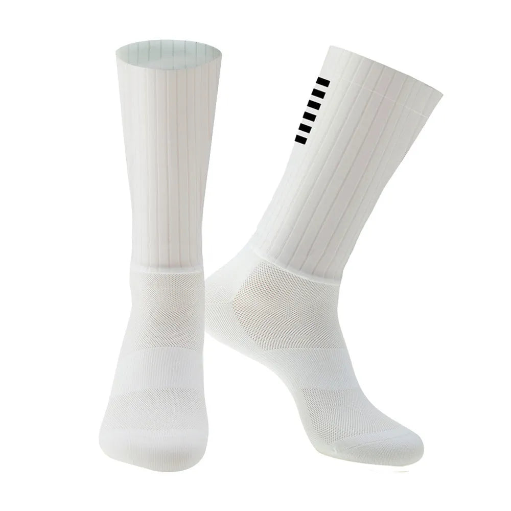 Pair of breathable athletic socks for running and cycling in orange colour on a grey background