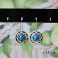 Handmade Miao silver turquoise earrings with geometric flower disk design and ethnic patterns
