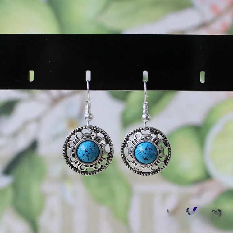 Handmade Miao silver turquoise earrings with geometric flower disk design and ethnic patterns