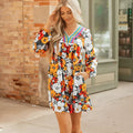 Orange floral print women's mini dress with striped lace trim, V-neck, and long sleeves.
