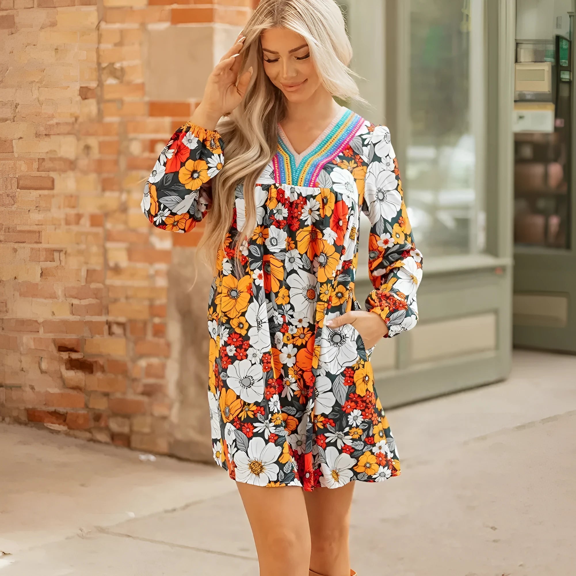 Orange floral print women's mini dress with striped lace trim, V-neck, and long sleeves.