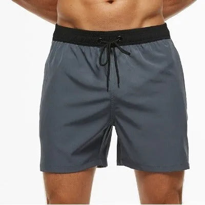 Men's blue fitness shorts with stitching waist detail, drawstring, and multiple pockets for gym workouts