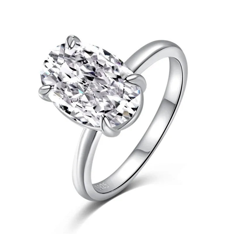 Oval women's ring with four-claw setting holding 6x9mm gemstone in gold or silver finish