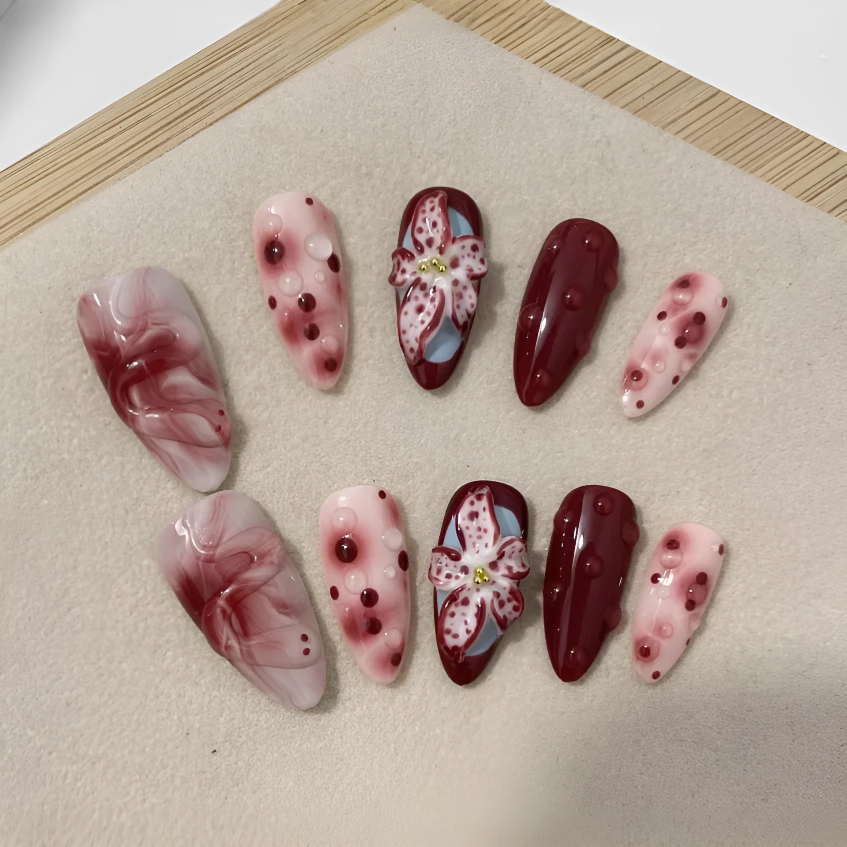 Hand-painted 3D carved manicure nails in almond colour with rose and tulip floral patterns