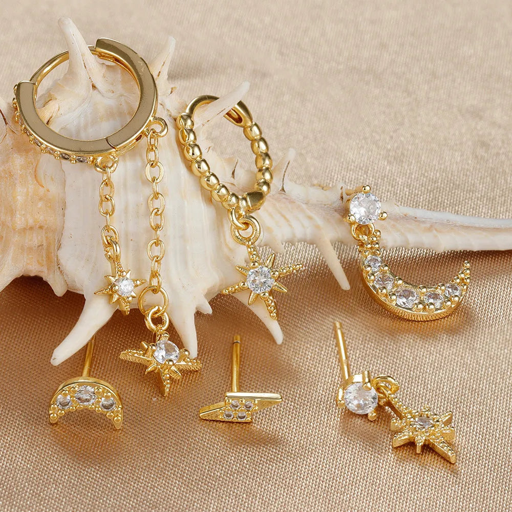 Set of six gold-coloured women's earrings with chain tassel designs and zircon studs on a white background.