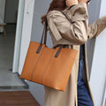 Women's genuine leather commuter shoulder bag with multiple internal zippered compartments in black colour