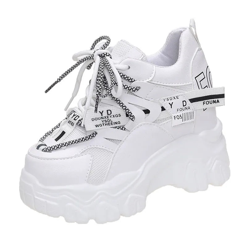 White and black women's mesh platform sports shoes with cross-strap and rubber sole.
