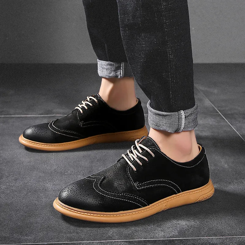 Men's black genuine cowhide business lace-up shoes with leather toe cap on a grey background.