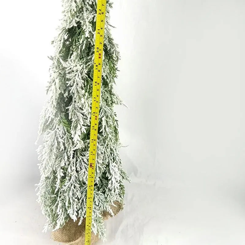 Small 24-inch white artificial Christmas tree with LED lights and snow spray on plastic branches