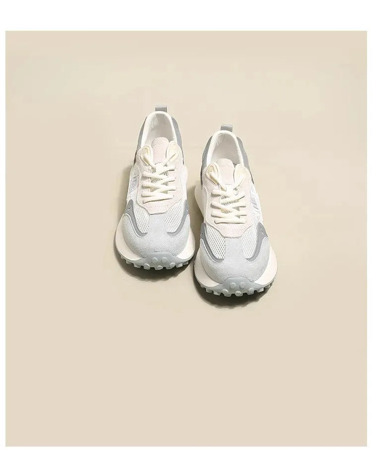 Women's low-top retro sneaker in grey with round toe, rubber sole, and mesh lining.