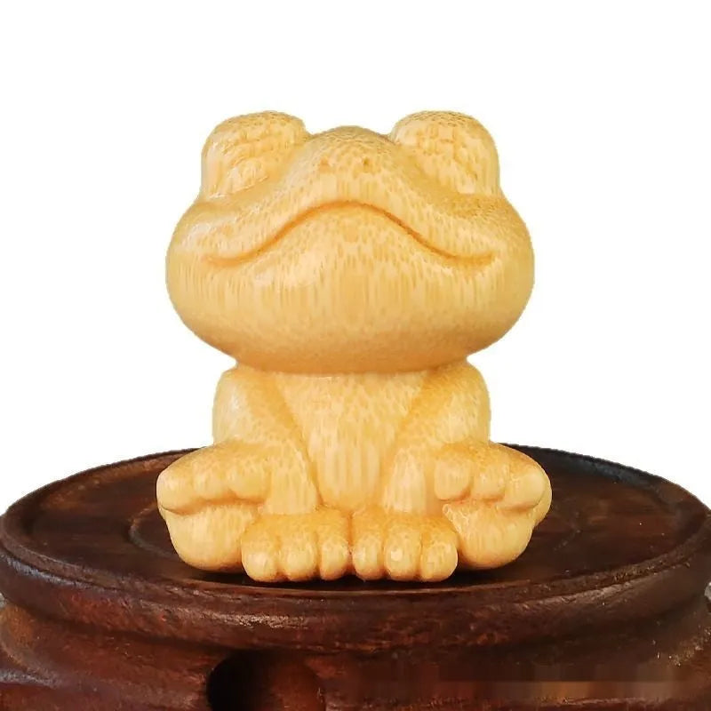 Solid bamboo smiling frog carving ornament measuring 5cm tall with cartoon design