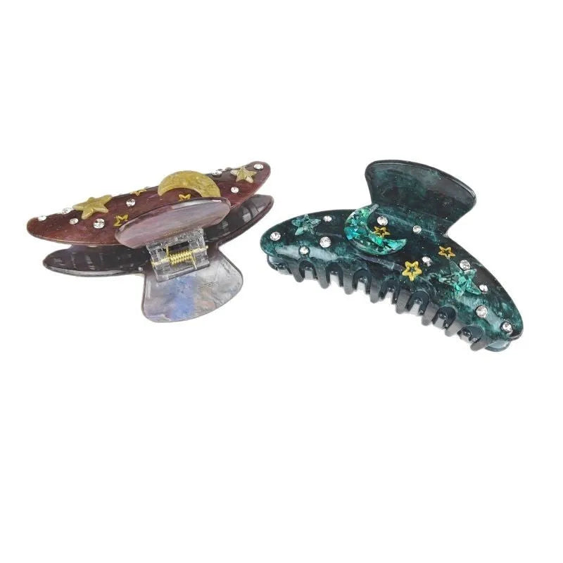 Oversized women's barrette with a starry sky design in blue, made from cellulose acetate sheet.