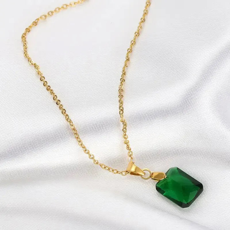 Copper geometric necklace with green rectangular quadrilateral pendant on an O-ring chain.