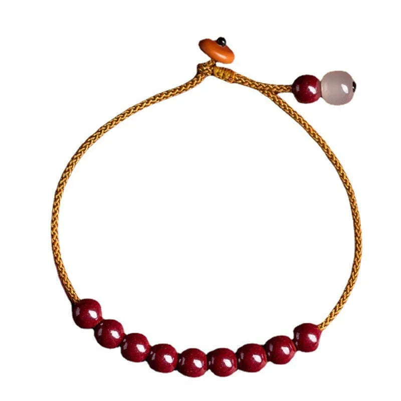 Hand-woven cinnabar geometric bracelet showing raw ore material texture and adjustable design