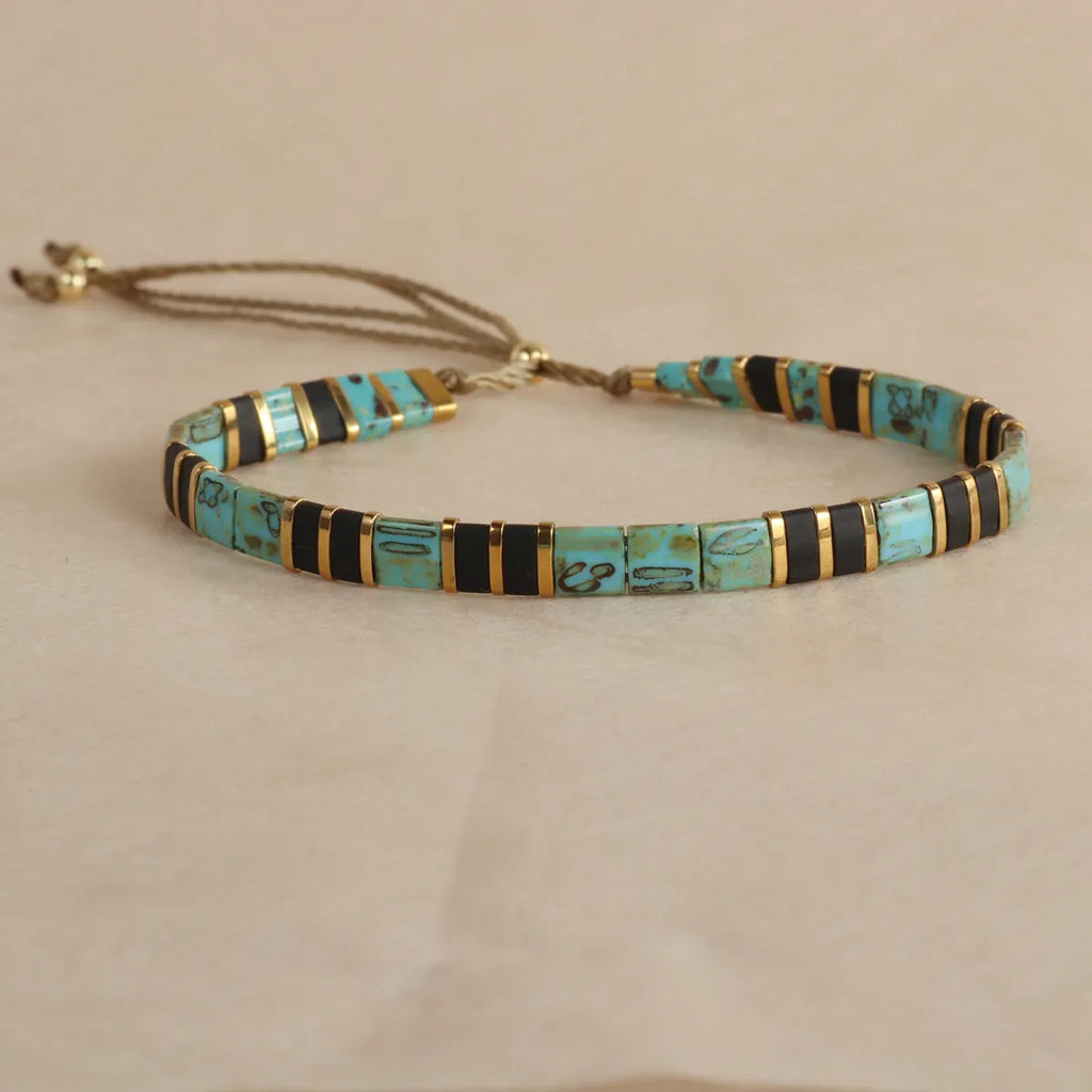 Geometric pull bead bracelet with round glass beads in multiple colour options.