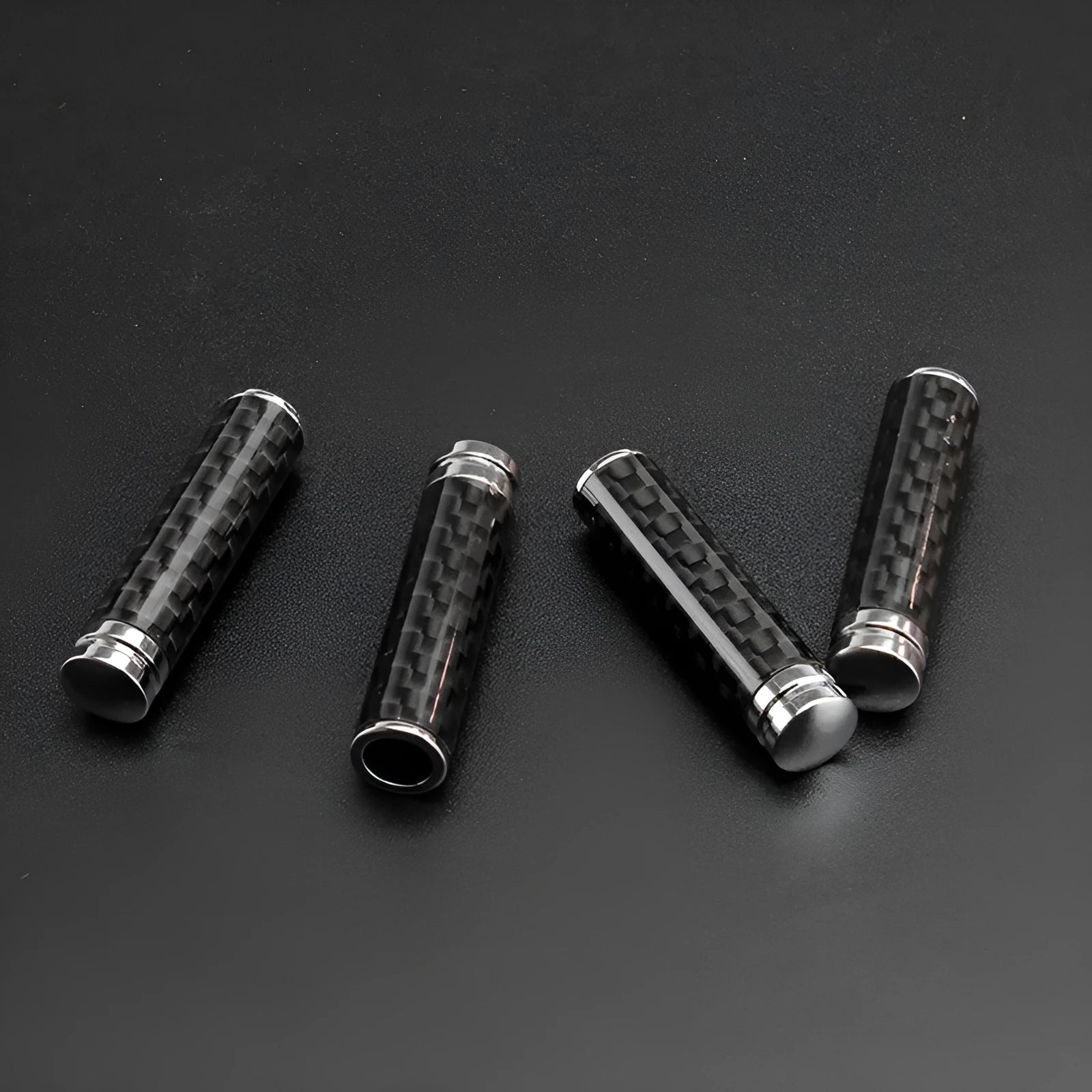 Set of four carbon fibre and metal car door lift handle covers for direct replacement installation.