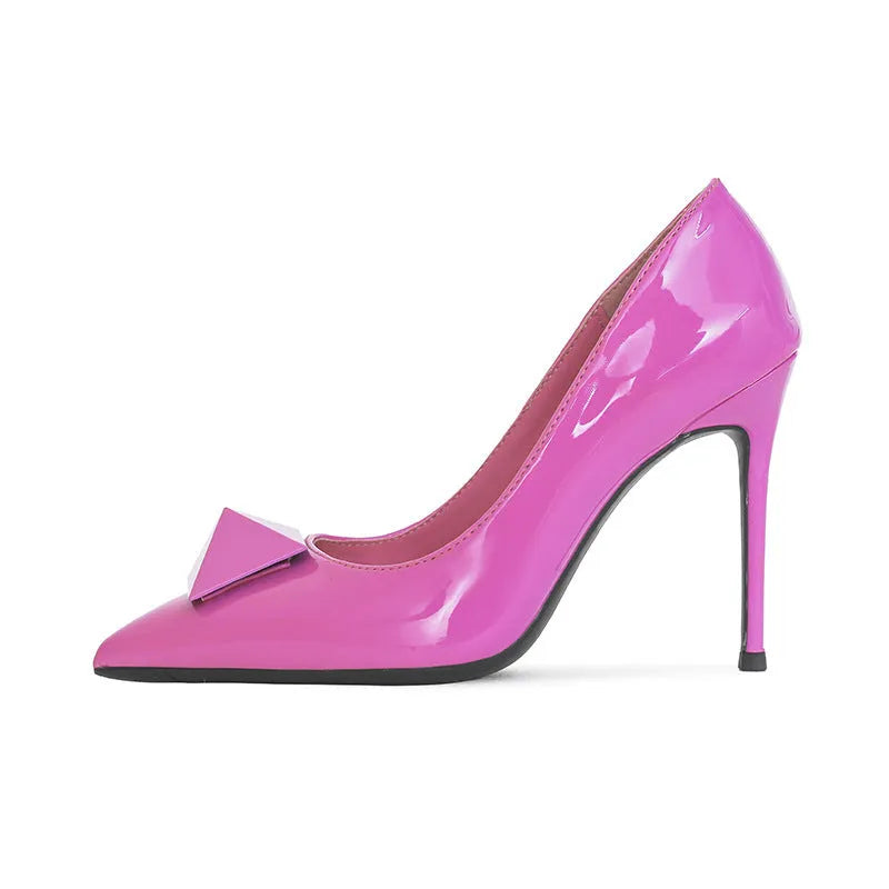 Women's pink patent leather pointed toe stiletto high heels with rivet and buckle decoration.