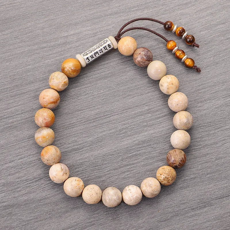 Handmade wood colour stone bead bracelet with retro design on a wrist