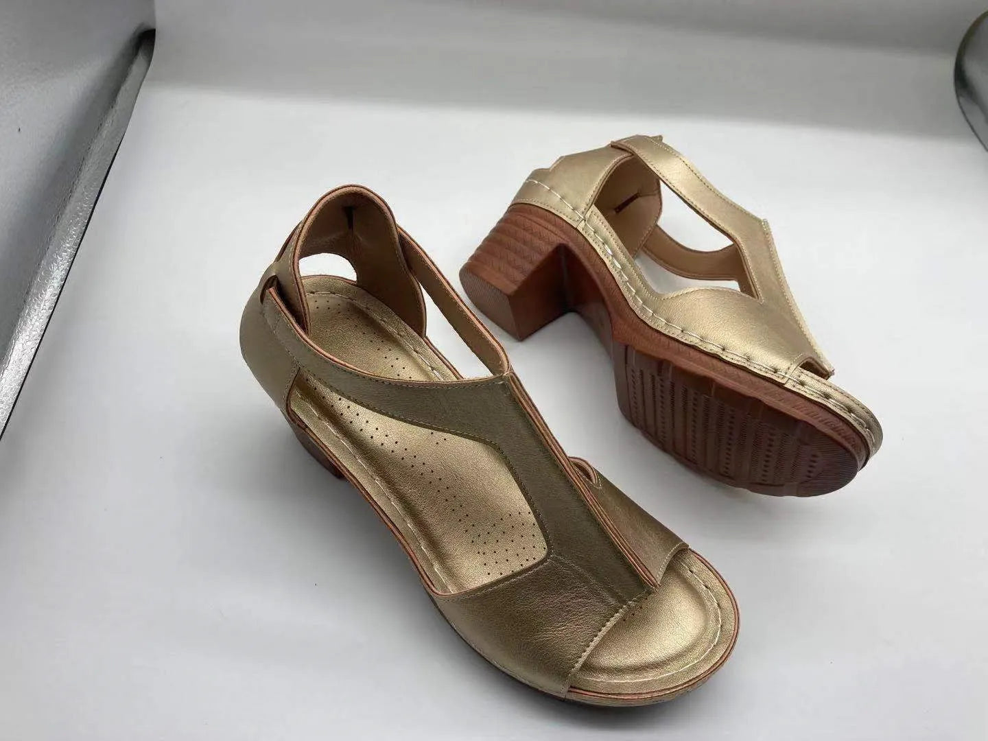 Women's peep toe wedge sandals with a buckle strap, shown in a light brown colour on a white background.